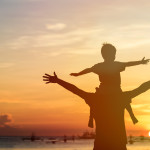 father and son on sunset beach