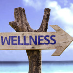 Wellness wooden sign on a beautiful day