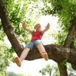 Little girl climbed on tree